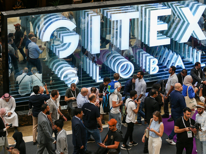 Crowds attending GITEX Global 2025 at the Dubai World Trade Centre, with a large illuminated “GITEX Global” sign as the backdrop.